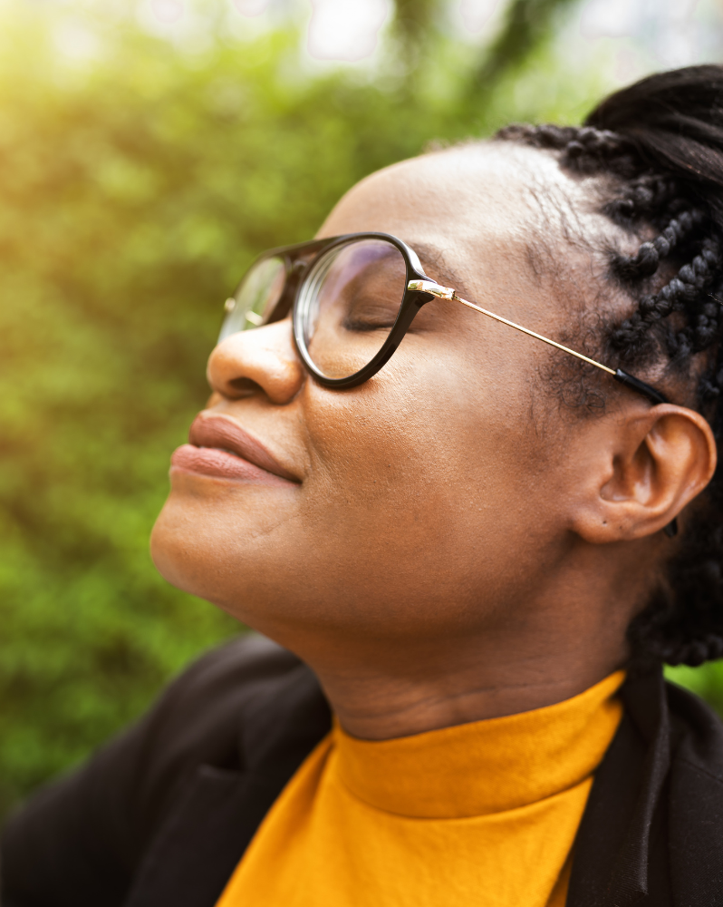 Woman breathing in fresh air with eyes closed