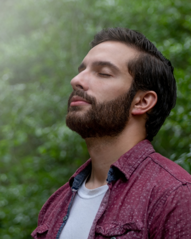 Man taking a deep breath with eyes closed